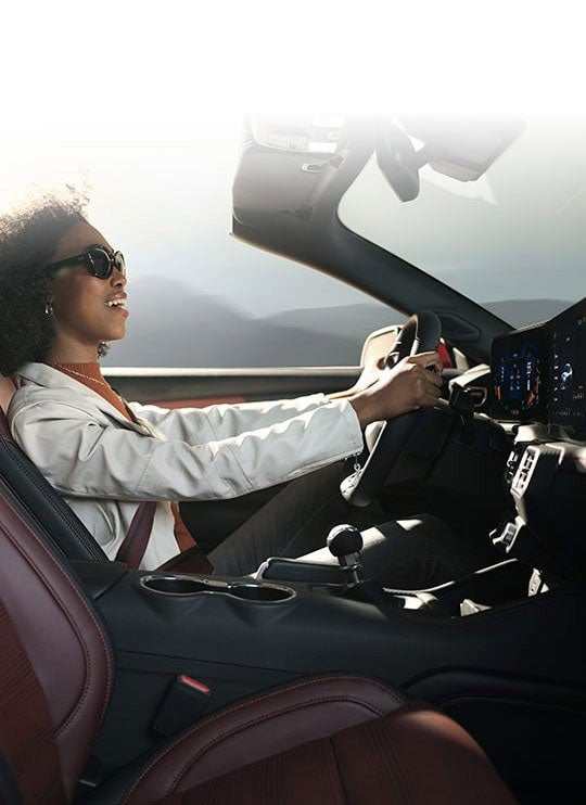 Person sitting in the driver’s seat of a 2024 Ford Mustang® convertible | Parks Ford of Wesley Chapel in Wesley Chapel FL